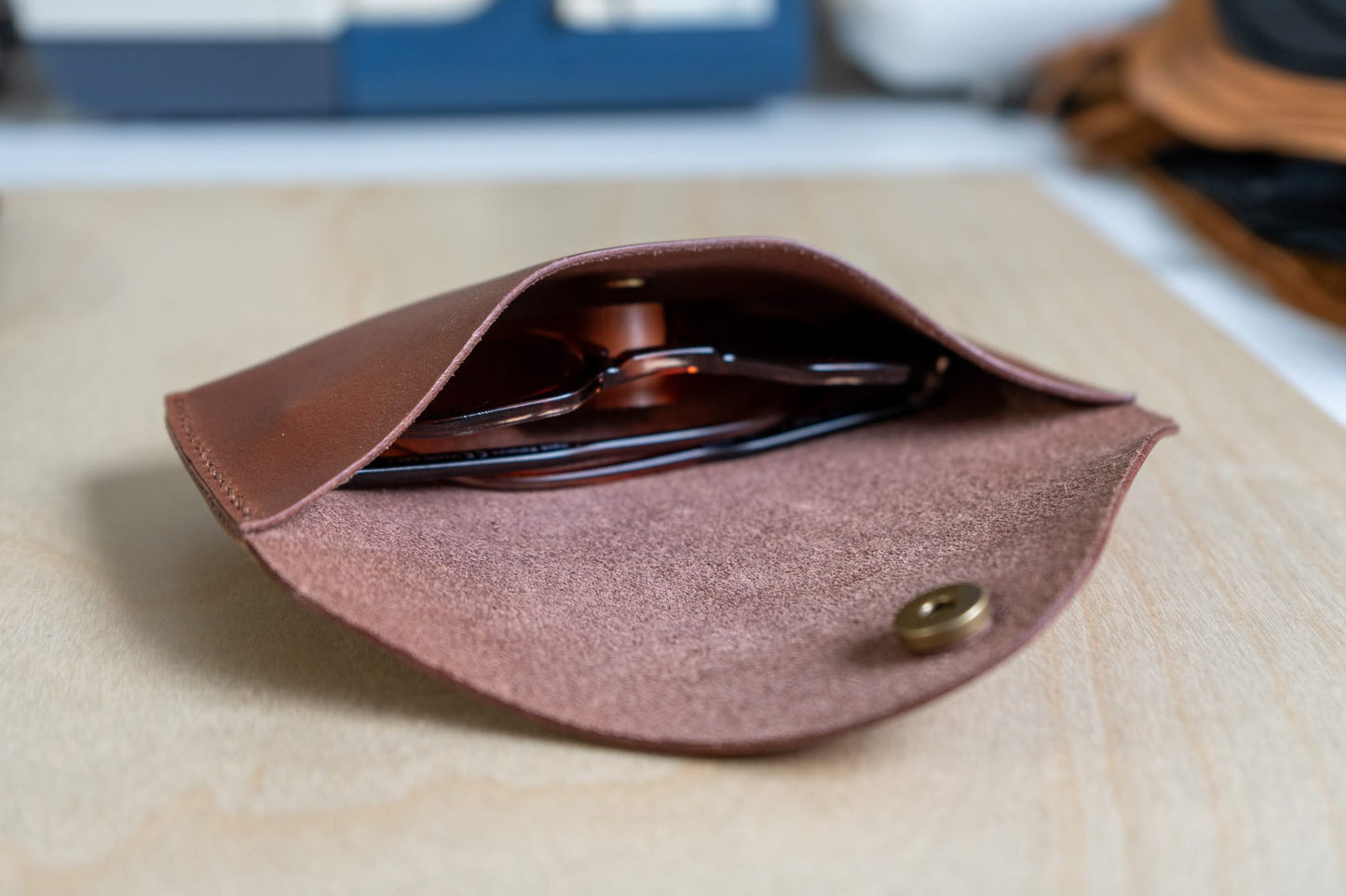 brown sunglass case with sunglass inside