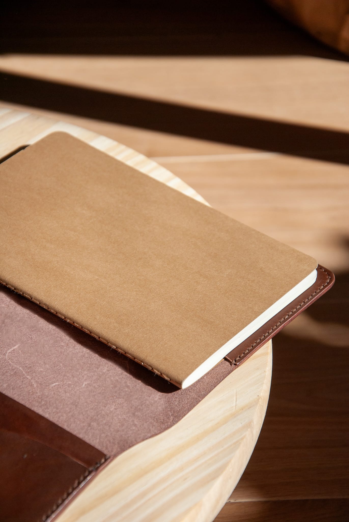 Brown leather-bound notebook on a wooden surface