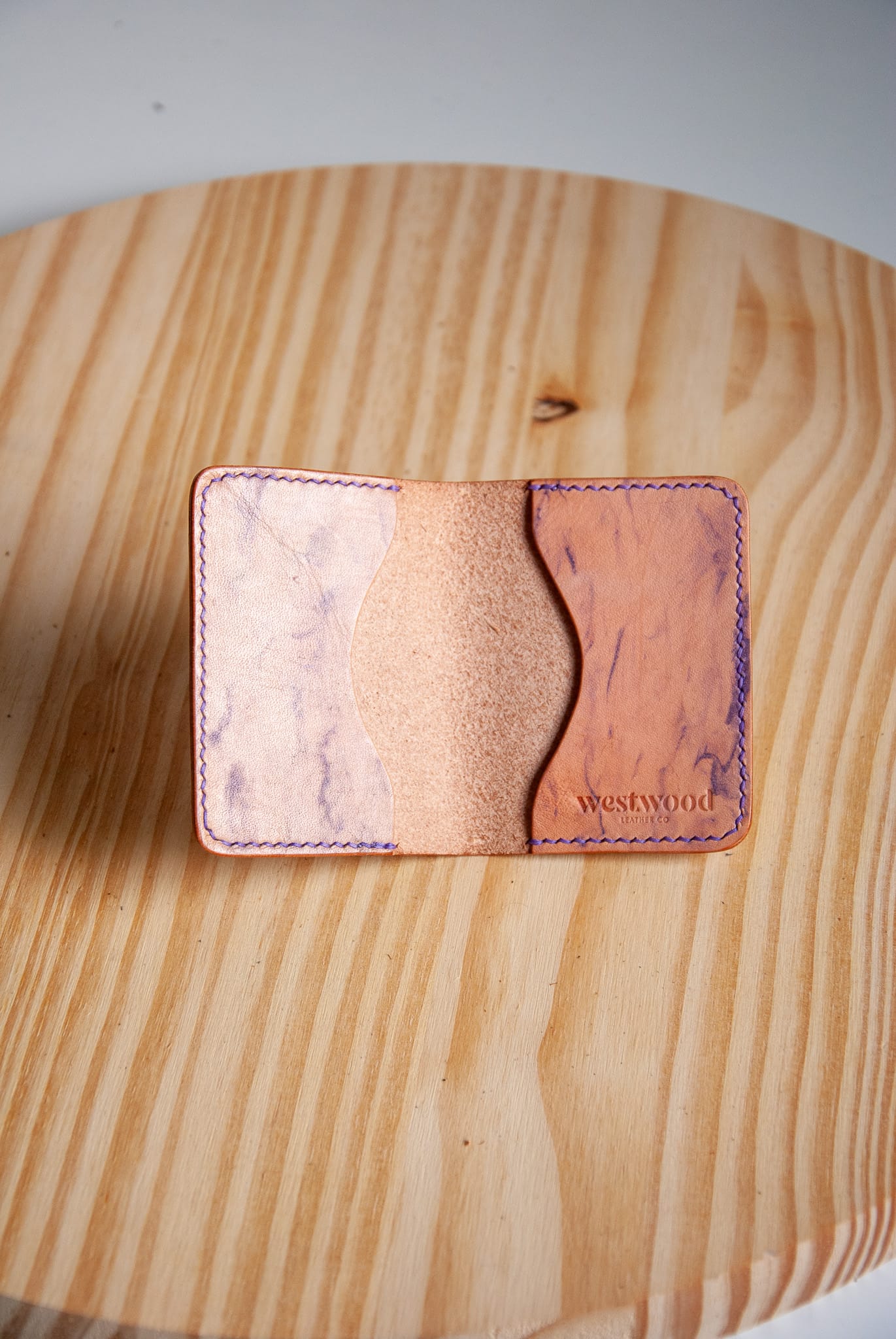 Cardholder with marbled design on a wooden surface