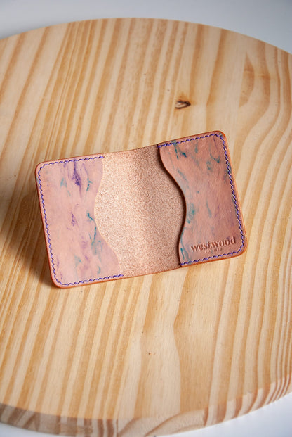 Cardholder with marbled pattern on a wooden surface