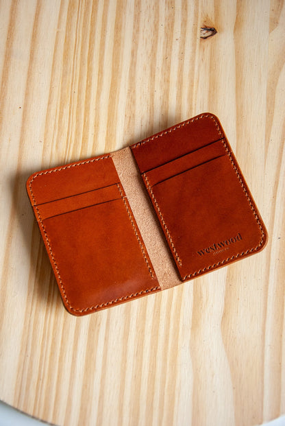 Brown leather wallet on a wooden surface